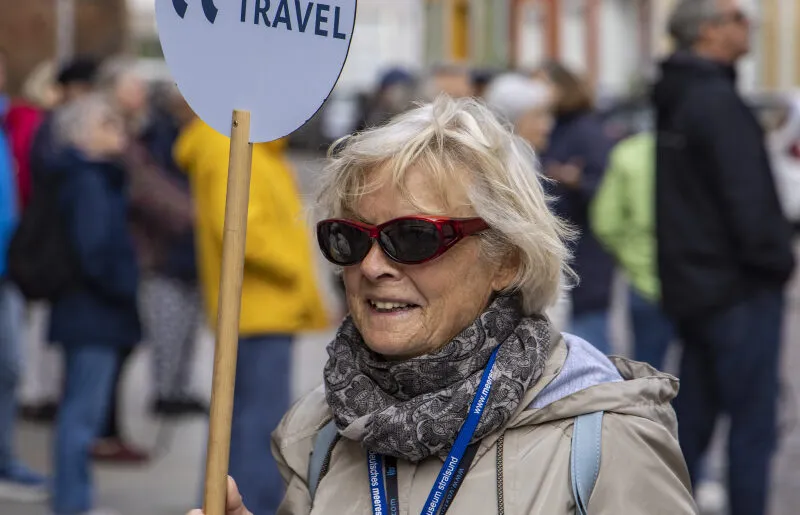 Tour guide holds Thurgau Travel tour sign, Stralsund, Mecklenburg-Western Pomerania, Germany