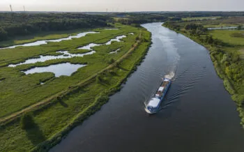 Aerial of boutique river cruise ship MS Thurgau Saxonia (Thurgau Travel) on Alte Oder river in Nationalpark Unteres Odertal, Mescherin, Mecklenburg-Western Pomerania, Germany