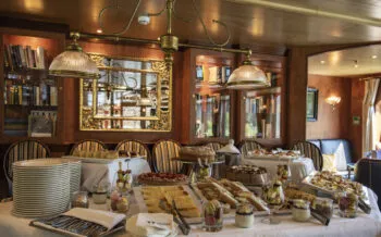 High tea buffet with cakes and sandwiches in panorama salon aboard boutique river cruise ship MS Thurgau Saxonia (Thurgau Travel), near Eberswalde, Brandenburg, Germany