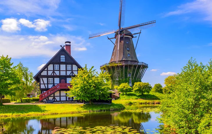 © Andreas Fischer - stock.adobe.com - bunte Windmühle in Gifhorn am See im Sommer
